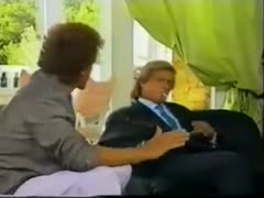 On the couch, an elderly blonde lady rides her friend's large pecker.